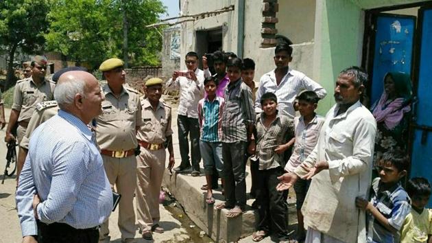 Uttar Pradesh home secretary Mani Prasad Mishra interacts with villagers in Shabeerpur on Wednesday.(HT file photo)