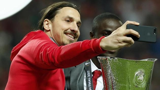 Manchester United’s Zlatan Ibrahimovic, who is injured and sat out the UEFA Europa League final -- clicks a selfie with the trophy alongside Eric Bailly during the final against Ajax Amsterdam at Friends Arena in Stockholm. Zlatan, from Sweden, was visiting his “home” stadium and was greeted by fans with loud cheers whenever they got glimpse of him. (Getty Images)