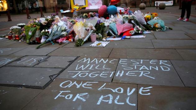 A woman looks at flowers for the victims of the Manchester Arena attack, in central Manchester Britain. (Reuters) A woman looks at flowers for the victims of the Manchester Arena attack, in central Manchester Britain. (Reuters)