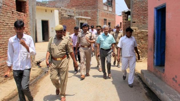 Administrative officials and the police patrol in the violence-hit Sabbirpur village of Saharanpur district on Thursday.(PTI Photo)