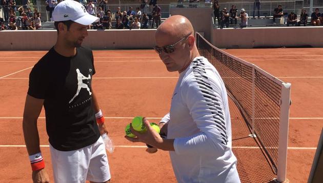 Novak Djokovic and Andre Agassi (right) during a training session ahead of the French Open(Twitter-Roland Garros) Novak Djokovic and Andre Agassi (right) during a training session ahead of the French Open(Twitter-Roland Garros)