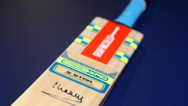 The cricket bat, signed by Britain's Prince Charles, will be donated to charity. (AFP)