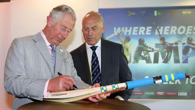 Britain's Prince Charles signs a cricket bat, which will be donated to charity, during the launch of the ICC Champions Trophy 2017. (AFP)