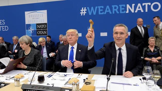NATO Secretary General Jens Stoltenberg (R) uses a hammer during the NATO summit near U.S President Donald Trump (C) and Britain's Prime Minister Theresa May (L) at the NATO headquarters, in Brussels, Belgium, May 25, 2017. (REUTERS Photo) NATO Secretary General Jens Stoltenberg (R) uses a hammer during the NATO summit near U.S President Donald Trump (C) and Britain's Prime Minister Theresa May (L) at the NATO headquarters, in Brussels, Belgium, May 25, 2017. (REUTERS Photo)