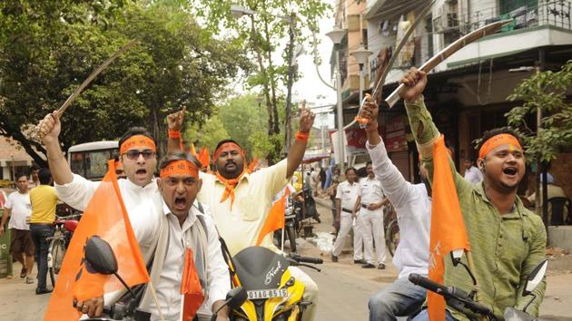 RSS workers, with swords in their hands, make a show of strength in Malda city of West Bengal.(Samir Jana/HT Photo)