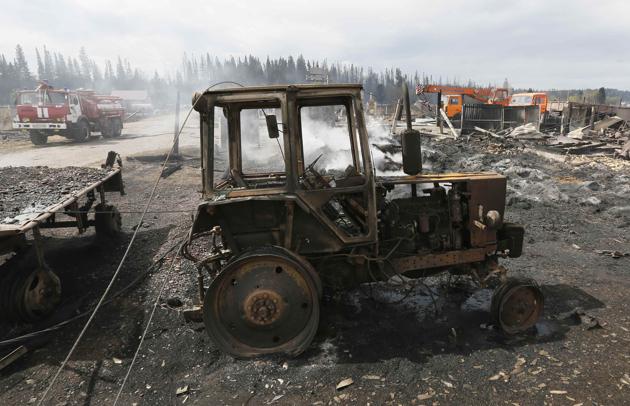 A view shows a tractor burnt during recent wildfire. Acting First Deputy Head of the National Crisis Management Center Igor Kutrovsky said, ‘a state of emergency has been declared in Kansk and Lesosibirsk.’ (Ilya Naymushin / Reuters) A view shows a tractor burnt during recent wildfire. Acting First Deputy Head of the National Crisis Management Center Igor Kutrovsky said, ‘a state of emergency has been declared in Kansk and Lesosibirsk.’ (Ilya Naymushin / Reuters)