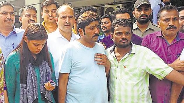 The suspects in police custody. The suspects in police custody.
