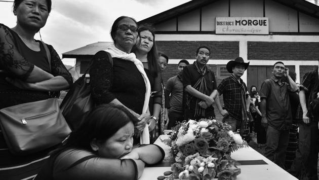Family members of Robert V Jamminthang gather around his coffin. After the violence and the killing, the town refused to bury its dead as an act of protest, in an attempt to force the government to agree to their demands. (Ravi Choudhary/HT PHOTO)