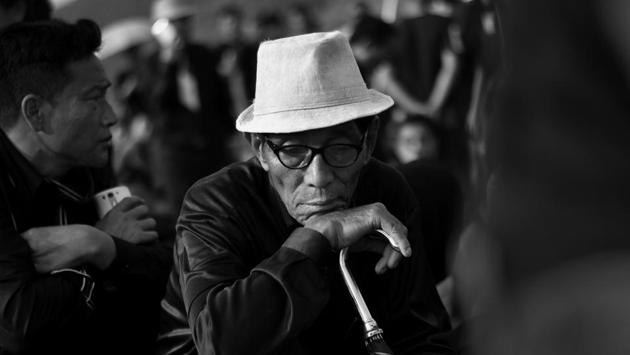 A man mourns the dead at the graveyard. The photos of the victims – ‘martyrs’ for the locals – were pasted on each coffin along with their names. Each coffin was placed on the back of a truck surrounded by family members and friends as their final journey began. (Ravi Choudhary/HT PHOTO)