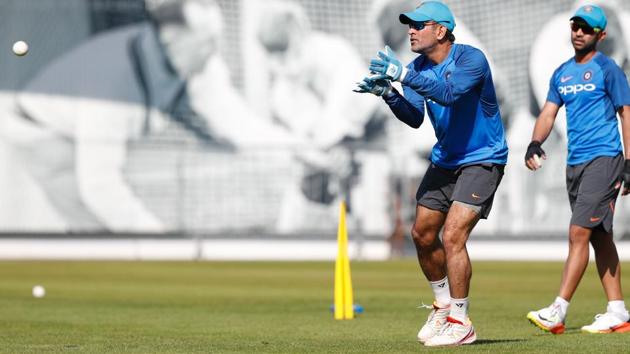 India's Mahendra Singh Dhoni takes a catch during a practice session at Lord's Cricket Ground in London. (AFP) 