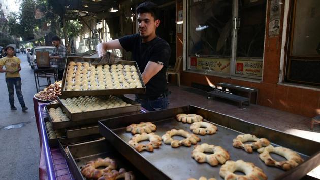 A man arranges sweets to be sold ahead of Ramadan in the rebel-held besieged city of Douma, in the eastern Damascus suburb of Ghouta, Syria. (Bassam Khabieh/REUTERS) A man arranges sweets to be sold ahead of Ramadan in the rebel-held besieged city of Douma, in the eastern Damascus suburb of Ghouta, Syria. (Bassam Khabieh/REUTERS)