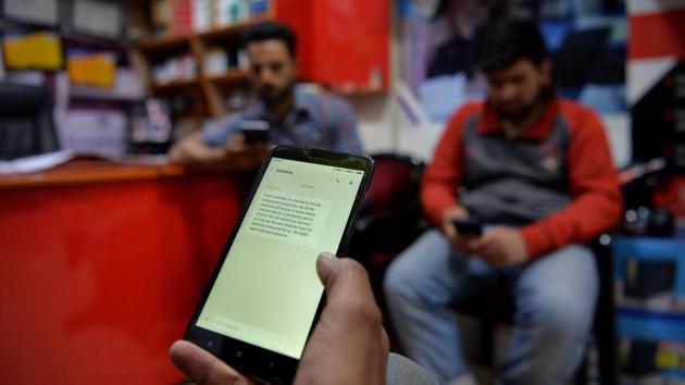 Three men browse the internet on mobile phones at a shop in Srinagar. Authorities have once again suspended mobile internet services.(AFP) Three men browse the internet on mobile phones at a shop in Srinagar. Authorities have once again suspended mobile internet services.(AFP)