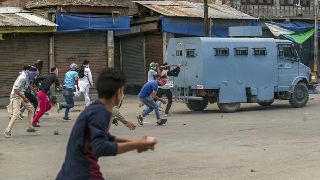 A protester throws rocks and bricks at an armoured vehicle belonging to paramilitary soldiers during a protest in Srinagar.(AP File Photo)