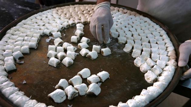 A man prepares traditional sweets, in Arbil, the capital of the Kurdish autonomous region in northern Iraq. (Safin Hamed/AFP) A man prepares traditional sweets, in Arbil, the capital of the Kurdish autonomous region in northern Iraq. (Safin Hamed/AFP)