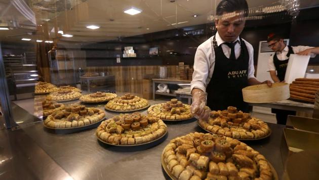 A man prepares to pack traditional sweets, in Arbil, the capital of the Kurdish autonomous region in northern Iraq. (Safin Hamed/AFP) A man prepares to pack traditional sweets, in Arbil, the capital of the Kurdish autonomous region in northern Iraq. (Safin Hamed/AFP)