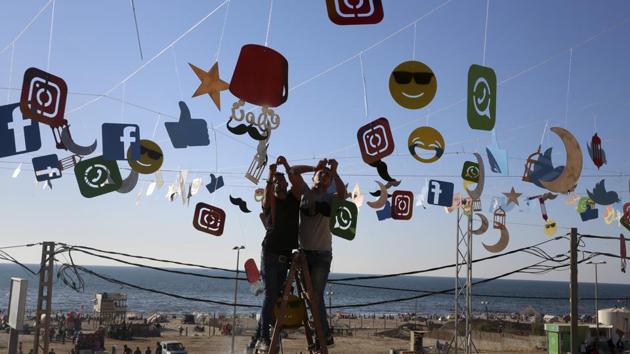 Workers decorate the seaside yard of a coffee at the main beach road, in Gaza City. (Adel Hana/AP) Workers decorate the seaside yard of a coffee at the main beach road, in Gaza City. (Adel Hana/AP)