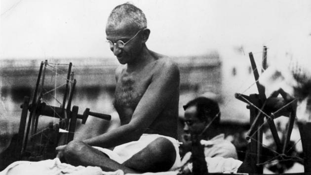 A vintage photograph of Mohandas Karamchand Gandhi, better known as the Mahatma, with his charkha.(Getty Images)