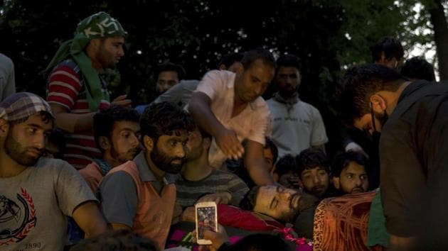 Kashmiri villagers crowd near the body of Hizbul militant Sabzar Ahmad Bhat in south Kashmir’s Tral on Saturday, a few hours after he and an associate were killed in a gunfight with security forces.(Yasin Dar / AP photo)