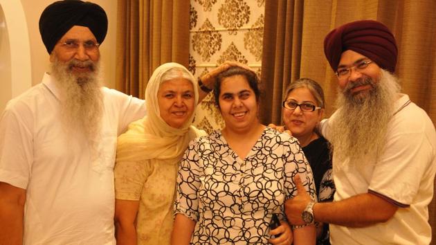 Gurleen Kaur who got 89% in her Class 12, with her family members in Jalandhar, India on Sunday.(Pardeep Pandit/HT)