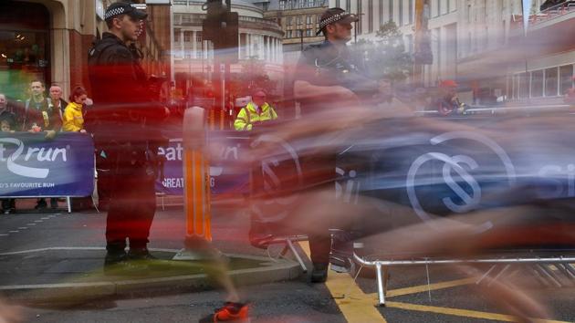 Armed police officers keep watch over junior runners competing in the Great Manchester Run in central Manchester, Britain . (Phil Noble / REUTERS)