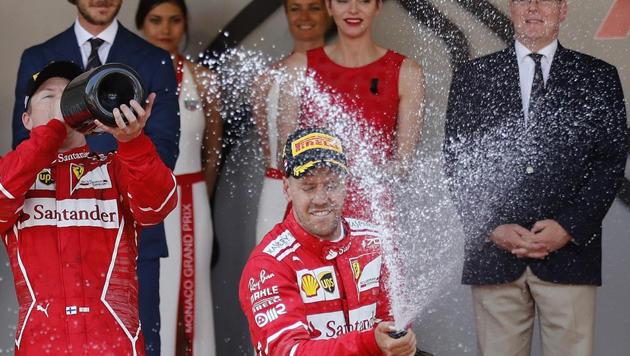 Sebastian Vettel sprays champagne on the podium after winning the Monaco Formula One Grand Prix.(AP)