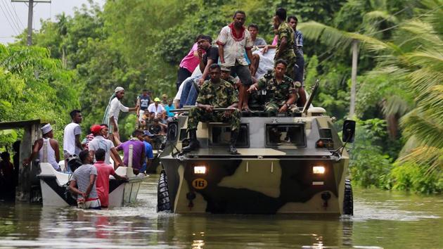 Sri Lankan soldiers evacuate flood victims in Wehangalla village in Kalutara district, Sri Lanka. (AP Photo) Sri Lankan soldiers evacuate flood victims in Wehangalla village in Kalutara district, Sri Lanka. (AP Photo)