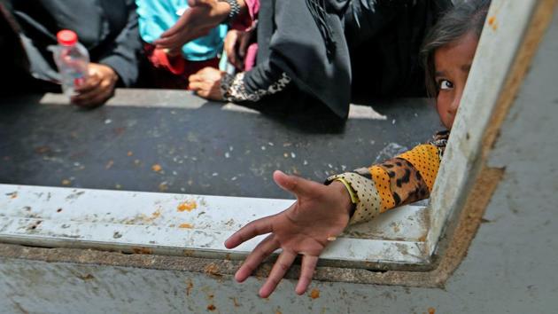 An Iraqi child waits for food rations upon arriving in a safe area after leaving their homes west of Mosul, as government forces continue their offensive to retake the city of Mosul from Islamic State (IS) group fighters. (KARIM SAHIB / AFP)