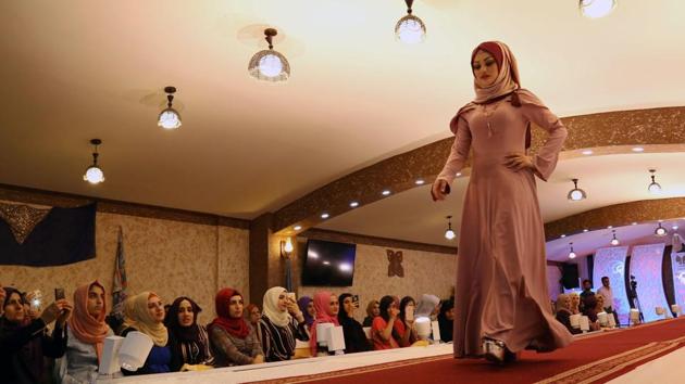 A Kurdish women walks down the runway during a Ramadan show for veiled women clothing in Arbil, the capital of the Kurdish autonomous region in northern Iraq. More than 1.5 billion Muslims around the world will mark the month, during which believers abstain from eating, drinking, smoking and having sex from dawn until sunset. (SAFIN HAMED / AFP)