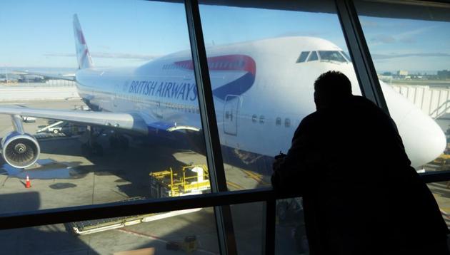 A passenger looks at a British Airway flight at John F. Kennedy (JFK) international airport in New York on Saturday.(AFP)