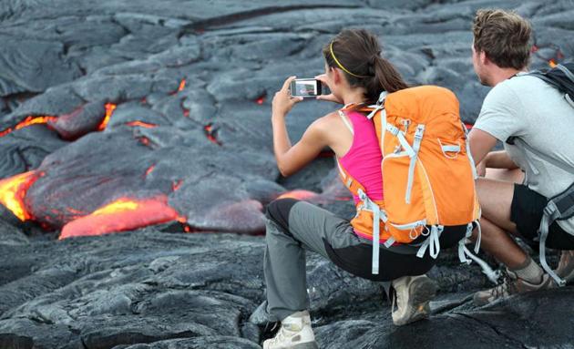 Tourists taking photo of flowing lava from Kilauea volcano around Hawaii volcanoes national park, USA. (Shutterstock) Tourists taking photo of flowing lava from Kilauea volcano around Hawaii volcanoes national park, USA. (Shutterstock)