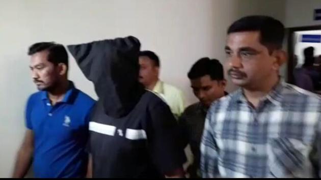 ATS personnel take one of the brothers, accused of having Islamic State links, into custody.(HT File)