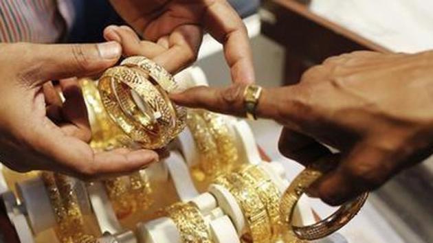 A man displays gold jewellery. (Reuters photo) A man displays gold jewellery. (Reuters photo)