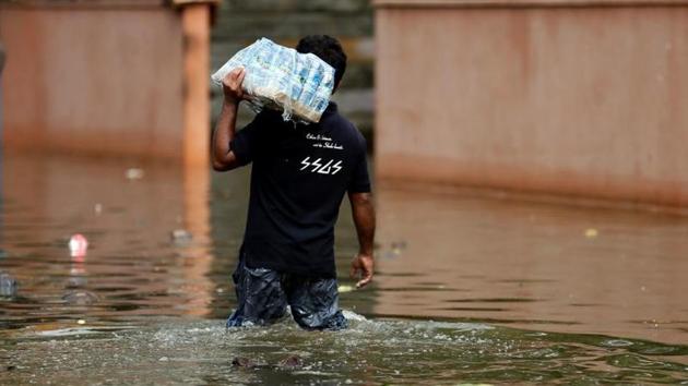 A man carries a pack of water bottles as he walks through a flooded road in Dodangoda village. Police said a Sri Lankan Air force helicopter (SLAF) MI-17 carrying relief aid for flood victims crashed in the southern Galle district, the worst hit of the 14 districts by flash floods and earth slips in the ongoing monsoon rains, while carrying out relief operations in the flooded areas. (Dinuka Liyanawatte/Reuters) A man carries a pack of water bottles as he walks through a flooded road in Dodangoda village. Police said a Sri Lankan Air force helicopter (SLAF) MI-17 carrying relief aid for flood victims crashed in the southern Galle district, the worst hit of the 14 districts by flash floods and earth slips in the ongoing monsoon rains, while carrying out relief operations in the flooded areas. (Dinuka Liyanawatte/Reuters)