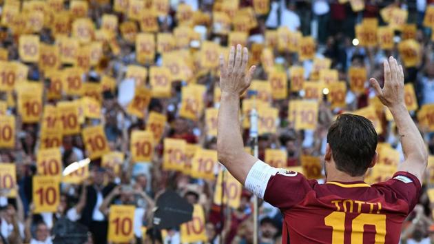 AS Roma's captain Francesco Totti greets fans during the ceremony. (AFP)