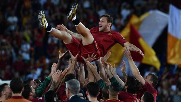 AS Roma players celebrate Roma's captain Francesco Totti. (AFP)