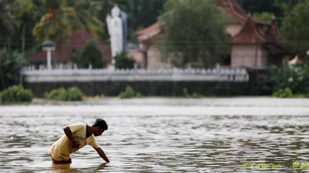 A man searches the water on a flooded road in Dodangoda village. The pilot lost control of the helicopter due to bad weather and crashed into woods, police said. (Dinuka Liyanawatte/Reuters) A man searches the water on a flooded road in Dodangoda village. The pilot lost control of the helicopter due to bad weather and crashed into woods, police said. (Dinuka Liyanawatte/Reuters)