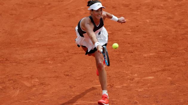 Garbine Muguruza stretches to make a return against Francesca Schiavone during their French Open first round match on Monday. (REUTERS) Garbine Muguruza stretches to make a return against Francesca Schiavone during their French Open first round match on Monday. (REUTERS)