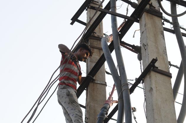 DHBVN officials said strong winds led to electric poles collapsing and overloading led to power lines tripping. (Parveen Kumar/HT) DHBVN officials said strong winds led to electric poles collapsing and overloading led to power lines tripping. (Parveen Kumar/HT)