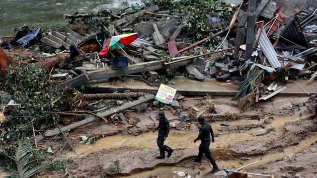 Sri Lankan army soldiers walk past the debris of houses at a landslide site. The Disaster Management Centre (DMC) said 104 people are still missing while 88 remain in hospital. (Dinuka Liyanawatte/Reuters) Sri Lankan army soldiers walk past the debris of houses at a landslide site. The Disaster Management Centre (DMC) said 104 people are still missing while 88 remain in hospital. (Dinuka Liyanawatte/Reuters)