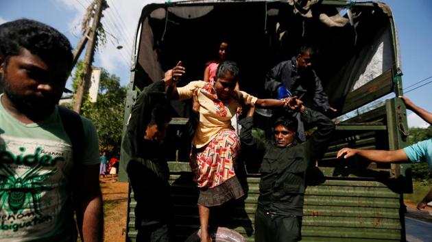 Sri Lankan army soldiers help a flood victim to get off from a truck during a rescue mission. On Saturday, a Lanka Air Force airman, YMS Yaparatne,37, died while carrying out relief operations in the Galledistrict as he fell off from the helicopter. (Dinuka Liyanawatte/Reuters) Sri Lankan army soldiers help a flood victim to get off from a truck during a rescue mission. On Saturday, a Lanka Air Force airman, YMS Yaparatne,37, died while carrying out relief operations in the Galledistrict as he fell off from the helicopter. (Dinuka Liyanawatte/Reuters)