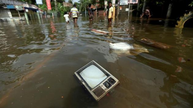 A TV set floats on a flooded road in Dodangoda village in Kalutara. Rescuers in Sri Lanka today pulled out more bodies buried in the mudslides triggered by the country’s worst torrential rains in 14 years, taking the death toll to 164. (Dinuka Liyanawatte/Reuters) A TV set floats on a flooded road in Dodangoda village in Kalutara. Rescuers in Sri Lanka today pulled out more bodies buried in the mudslides triggered by the country’s worst torrential rains in 14 years, taking the death toll to 164. (Dinuka Liyanawatte/Reuters)