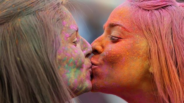Women kiss during the Indian inspired Holi Festival in Burgos, north of Spain. (CESAR MANSO / AFP)
