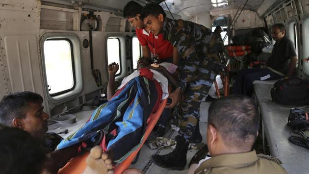 In this photo taken on Saturday, May 27, 2017, Sri Lankan air force personnel carry an elderly man into a helicopter after rescuing him in Kalawana, in Ratnapura district of Sri Lanka. (Rukmal Gamage/AP) In this photo taken on Saturday, May 27, 2017, Sri Lankan air force personnel carry an elderly man into a helicopter after rescuing him in Kalawana, in Ratnapura district of Sri Lanka. (Rukmal Gamage/AP)