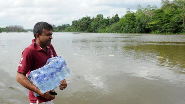A Sri Lankan flood victim carries water supplies through floodwaters in Dodangoda village. Following India’s lead in sending out emergency relief to Sri Lanka, more countries have started pledging assistance to provide relief to the flood victims. China is to donate relief items worth of USD 2.2 million. (Lakruwan wanniarachchi/AFP) A Sri Lankan flood victim carries water supplies through floodwaters in Dodangoda village. Following India’s lead in sending out emergency relief to Sri Lanka, more countries have started pledging assistance to provide relief to the flood victims. China is to donate relief items worth of USD 2.2 million. (Lakruwan wanniarachchi/AFP)