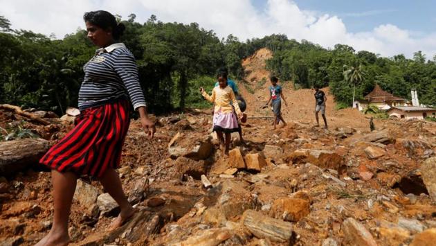People walk through a landslide site during a rescue mission. There were no casualties in the crash and Sri Lankan President Maithripala Sirisena telephoned the Squadron Leader Bhanuka Delgoda, the pilot of the MI-17 to congratulate him for his bravery. (Dinuka Liyanawatte/Reuters) People walk through a landslide site during a rescue mission. There were no casualties in the crash and Sri Lankan President Maithripala Sirisena telephoned the Squadron Leader Bhanuka Delgoda, the pilot of the MI-17 to congratulate him for his bravery. (Dinuka Liyanawatte/Reuters)