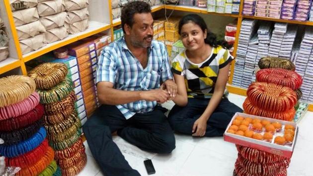 Vedanshi Gupta with her father at his bangle shop in Lucknow.(HT Photo) Vedanshi Gupta with her father at his bangle shop in Lucknow.(HT Photo)