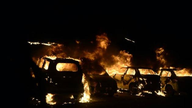 Four vehicles were set on fire in the violence near Peer Gate area in Old Bhopal on Tuesday night.(Mujeeb Faruqui/HT Photo)