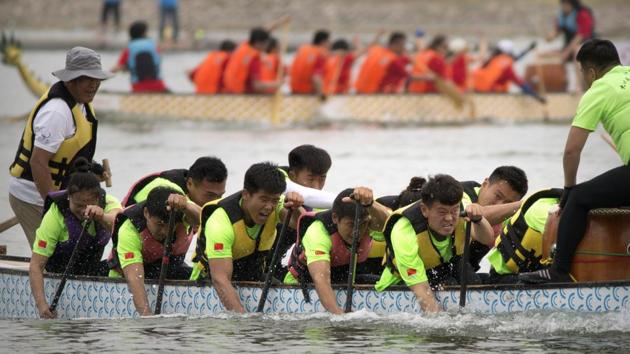Teams of dragon boat racers paddle their boats during the Dragon Boat festival at the Olympic Water Park in Beijing. (Mark Schiefelbein / AP)