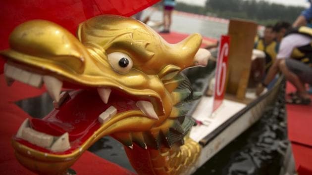 Crew members prepare their boat before a dragon boat race during the Dragon Boat festival . (Mark Schiefelbein /AP)