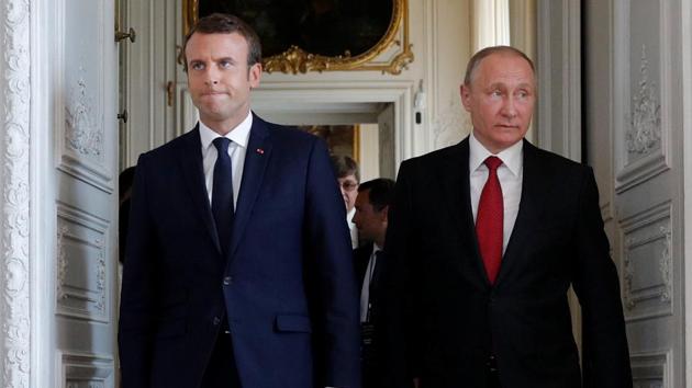 French President Emmanuel Macron (left) walks with Russian President Vladimir Putin at the Chateau de Versailles in Versailles, France.(Reuters Photo)